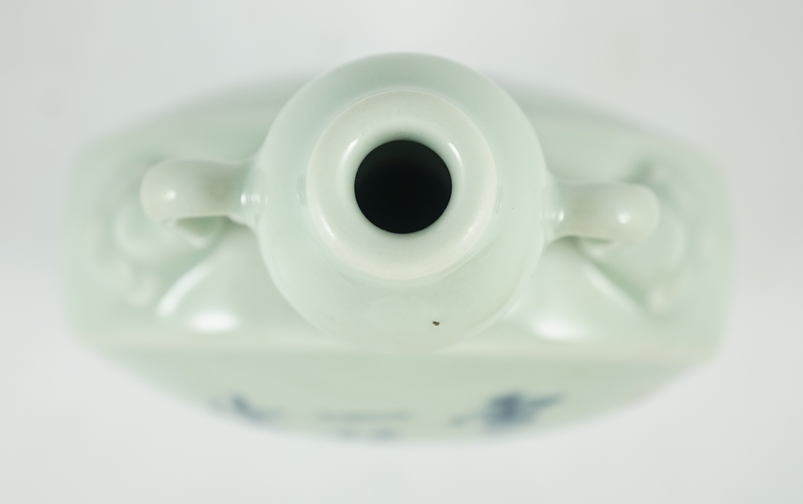 A Chinese underglaze blue and copper red inscribed celadon ground moonflask, 21cm high